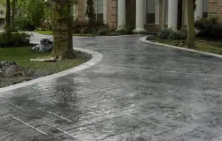 dark stamped concrete driveway