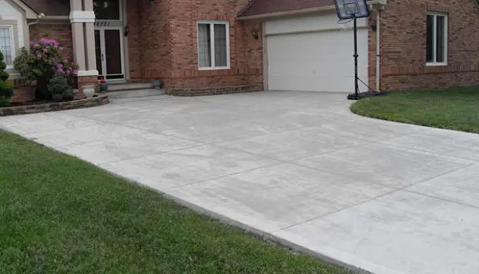 A newly installed concrete driveway on a residential home
