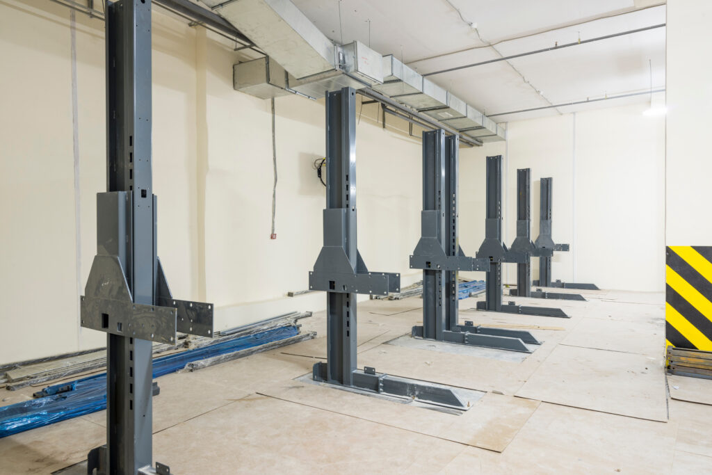 A row of hydraulic automotive lifts