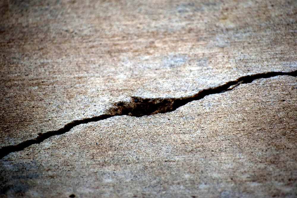 A large crack in a concrete patio