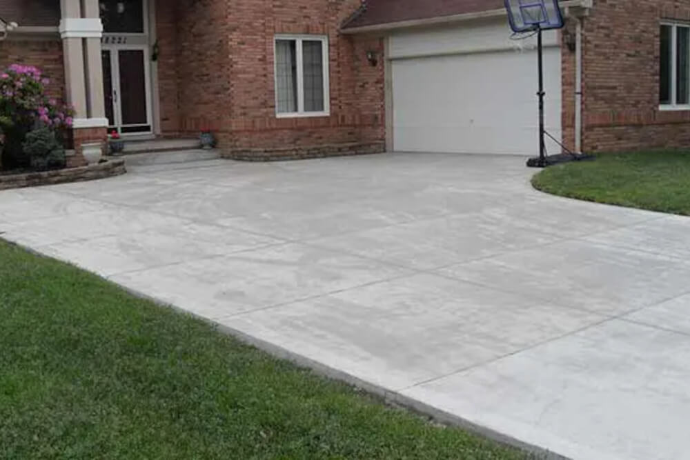 A newly installed concrete driveway on a residential home